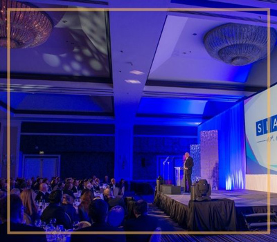 a stage and an audience for a corporate event